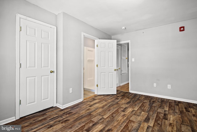 unfurnished bedroom featuring dark hardwood / wood-style floors