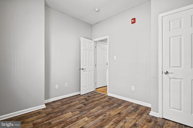 unfurnished bedroom featuring dark hardwood / wood-style floors