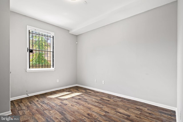 unfurnished room featuring dark wood-type flooring