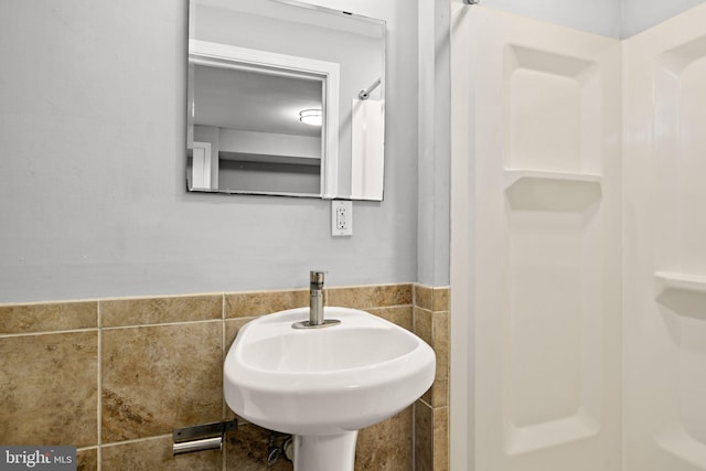 bathroom with tile walls