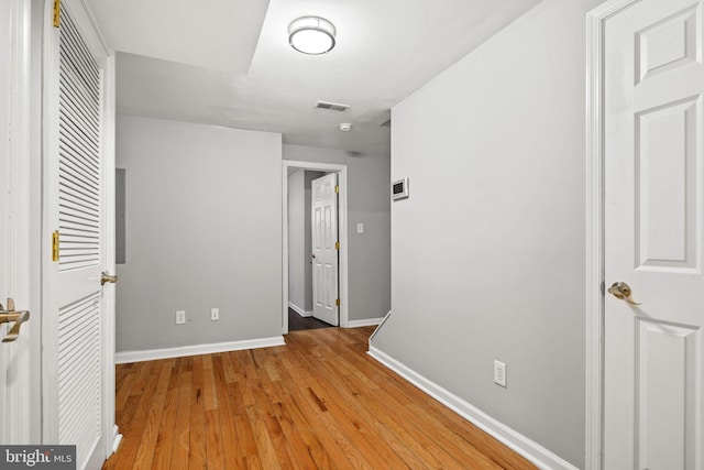 unfurnished bedroom featuring light wood-style floors, baseboards, and visible vents