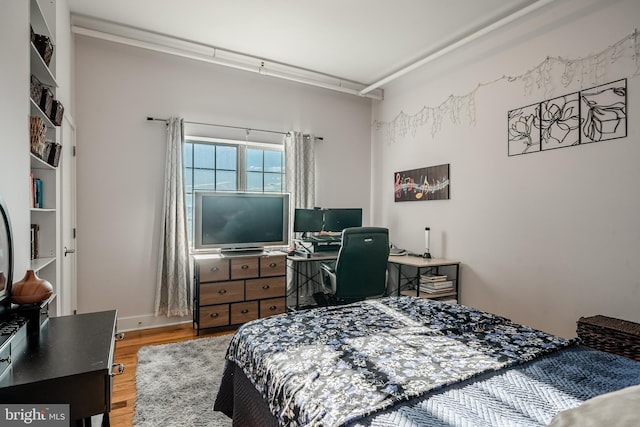 bedroom featuring wood finished floors