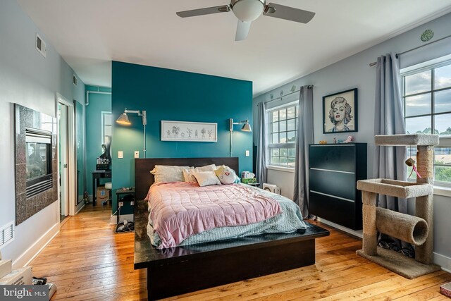 bedroom featuring light wood-type flooring and ceiling fan