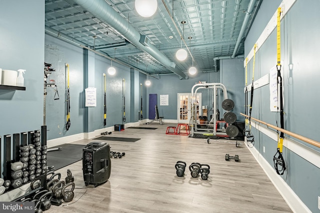 exercise room with hardwood / wood-style floors