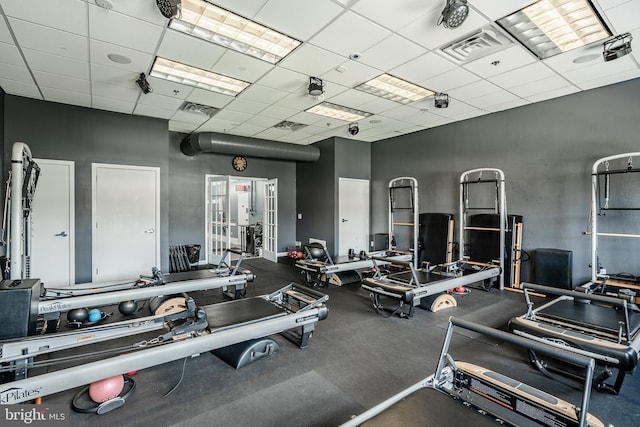 workout area with visible vents, a drop ceiling, and french doors