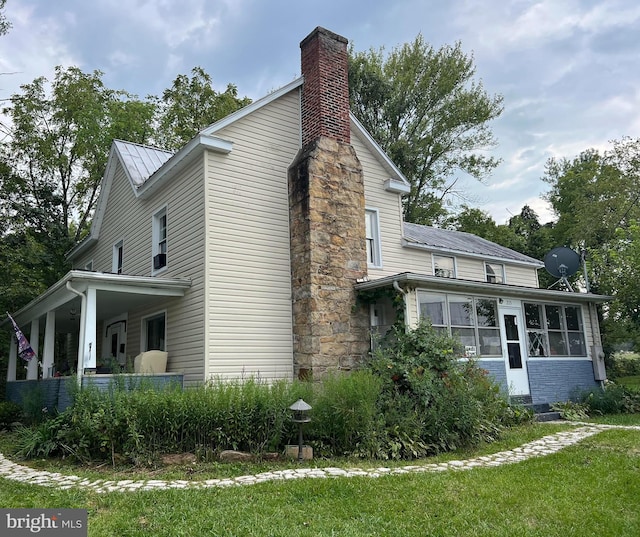 view of side of property with a yard