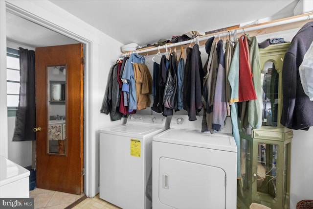 clothes washing area with washer and clothes dryer