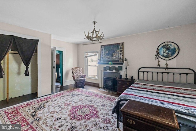 bedroom featuring hardwood / wood-style flooring and an inviting chandelier