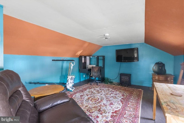 carpeted living room featuring lofted ceiling