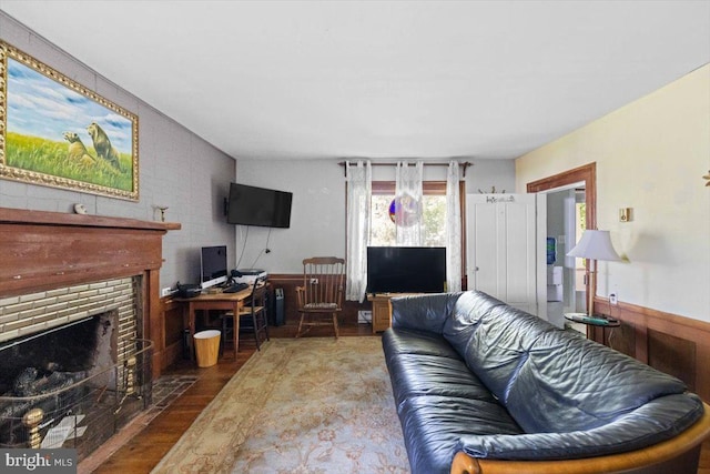 living room with dark hardwood / wood-style flooring and a fireplace