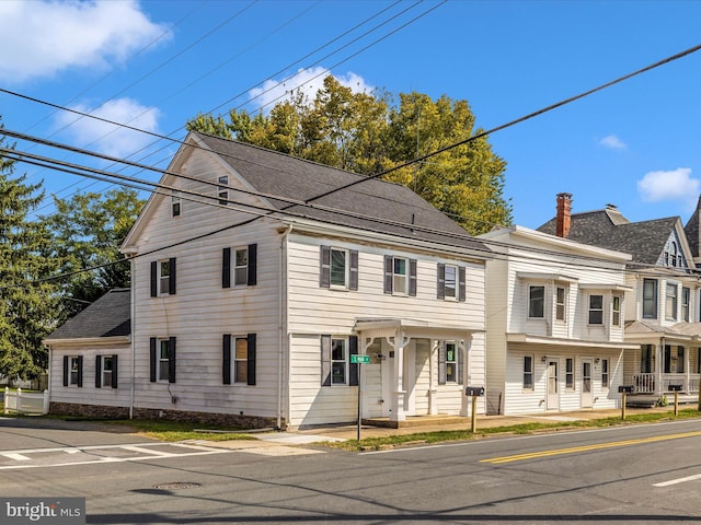 view of front of home featuring roof with shingles and a chimney