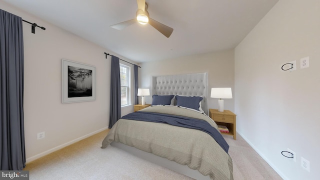 bedroom with light carpet, baseboards, and a ceiling fan