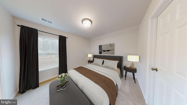 bedroom featuring light carpet, visible vents, and baseboards