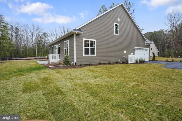 view of home's exterior featuring a yard, aphalt driveway, and an attached garage