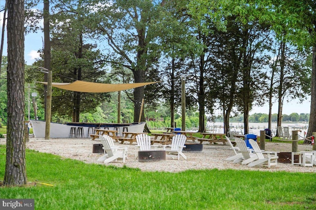 view of yard with an outdoor fire pit and a water view