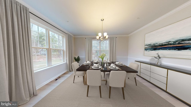 dining space with an inviting chandelier, light wood-style flooring, visible vents, and crown molding