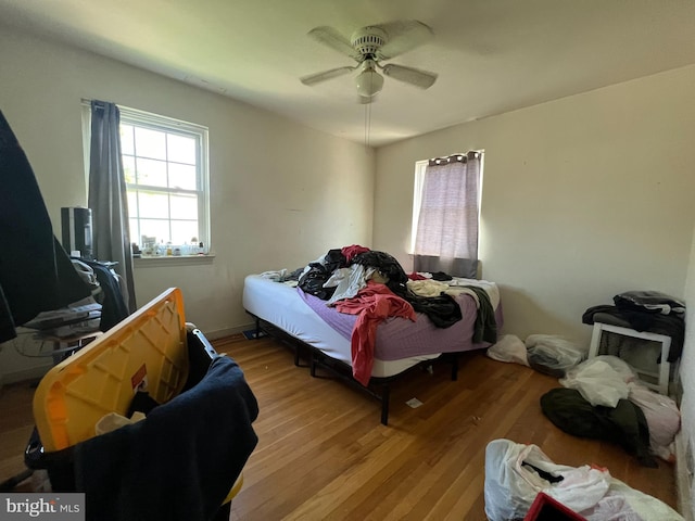 bedroom with wood-type flooring and ceiling fan