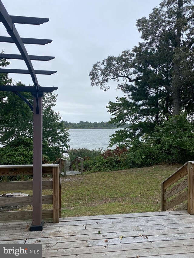 deck featuring a water view and a pergola