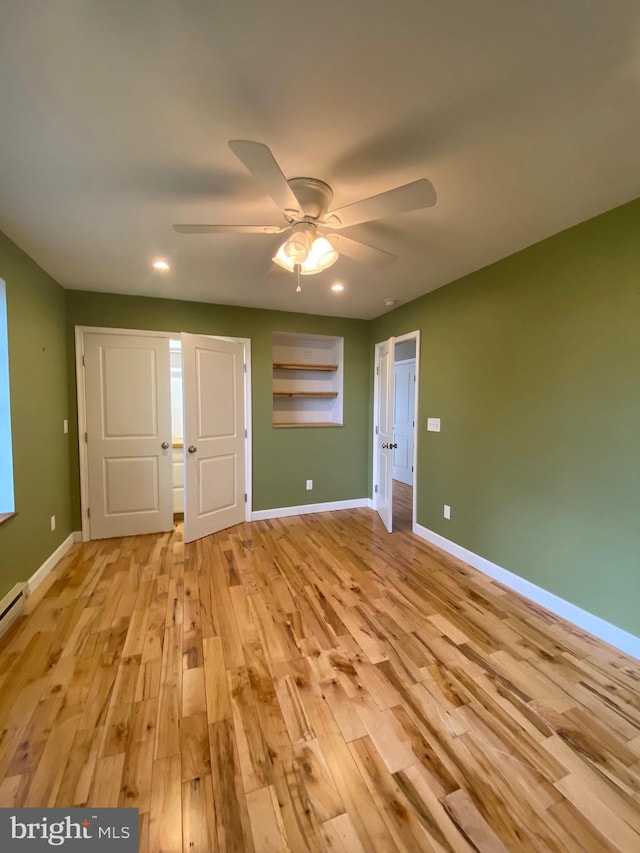 unfurnished bedroom featuring ceiling fan and light hardwood / wood-style floors