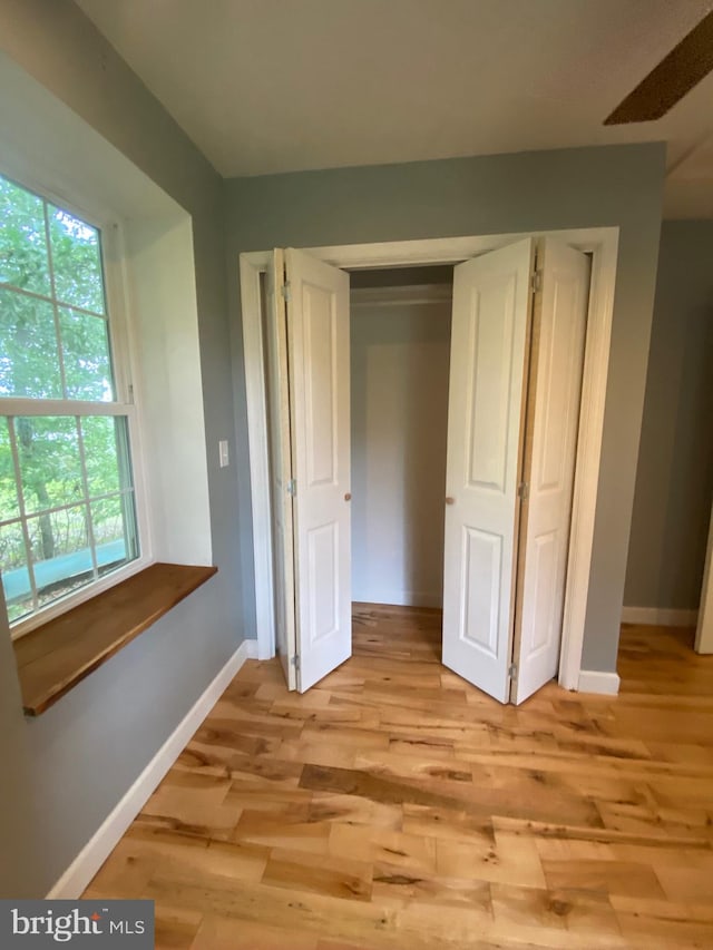 interior space with light hardwood / wood-style flooring and a closet