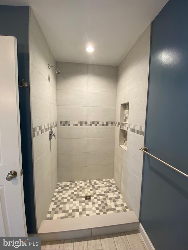 bathroom with tiled shower