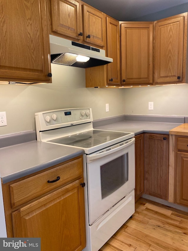 kitchen with light wood-type flooring and white range with electric cooktop