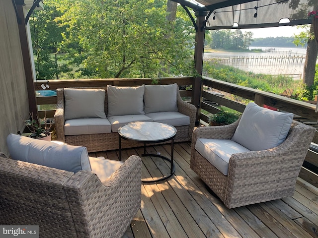 wooden deck featuring an outdoor hangout area and a water view