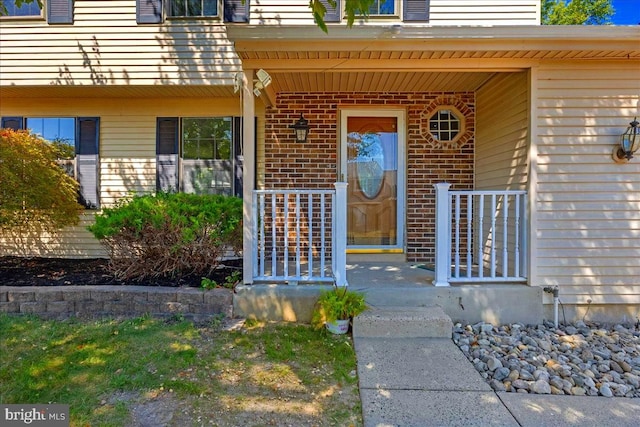 view of exterior entry featuring a porch