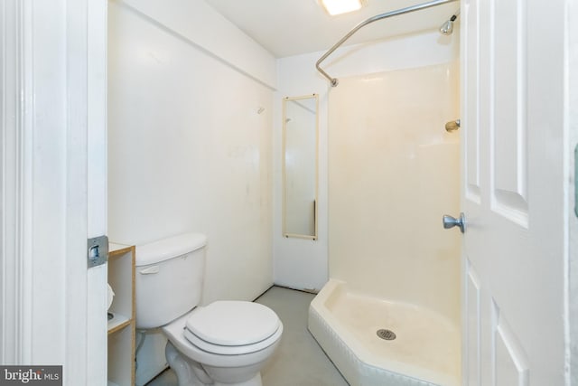 bathroom featuring toilet and walk in shower