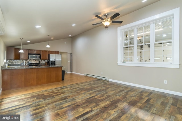 kitchen featuring pendant lighting, baseboard heating, appliances with stainless steel finishes, and dark hardwood / wood-style flooring