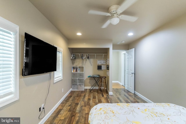 bedroom featuring ceiling fan, dark hardwood / wood-style floors, and a closet