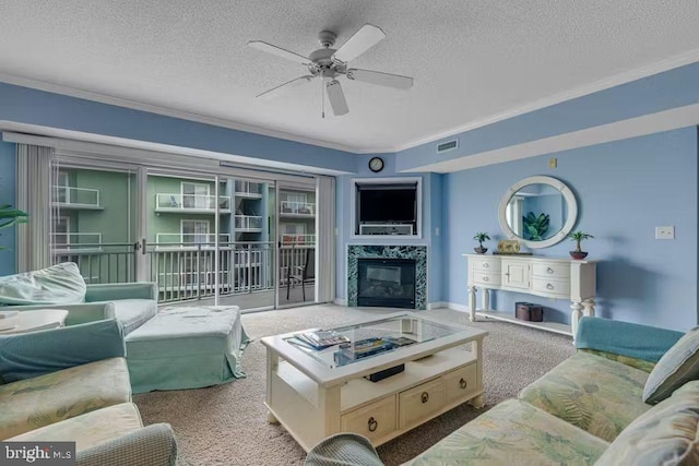 living room featuring a fireplace, light colored carpet, a textured ceiling, and ceiling fan