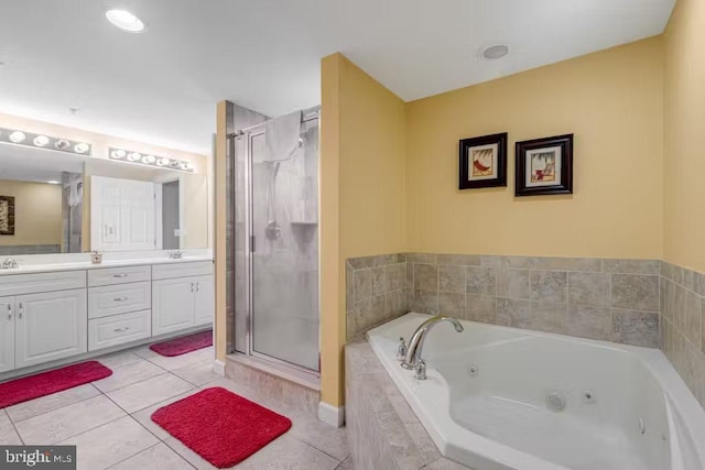 bathroom featuring independent shower and bath, vanity, and tile patterned floors