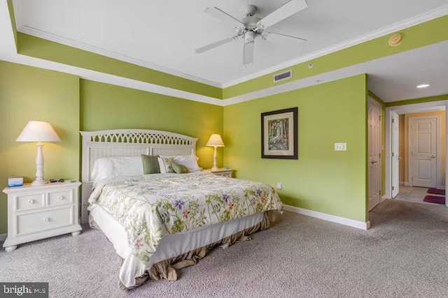 carpeted bedroom featuring ceiling fan and crown molding