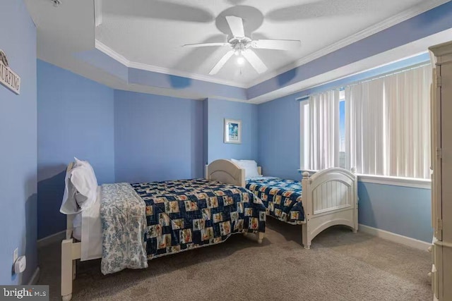 bedroom featuring ceiling fan, a tray ceiling, crown molding, and light colored carpet