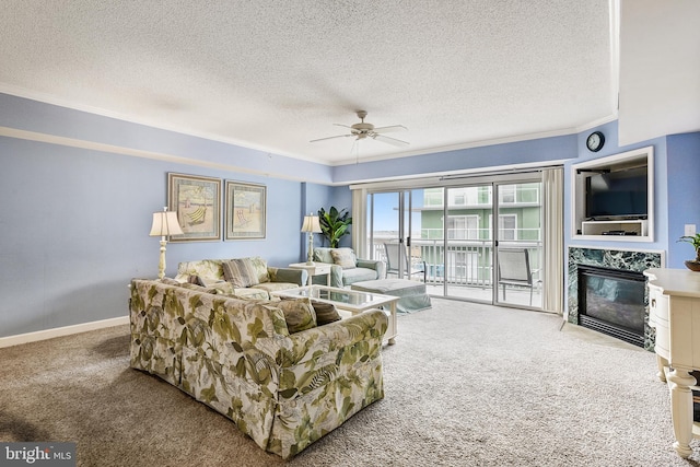 carpeted living room featuring ornamental molding, a textured ceiling, a high end fireplace, and ceiling fan