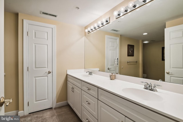 bathroom with vanity, tile patterned flooring, and toilet