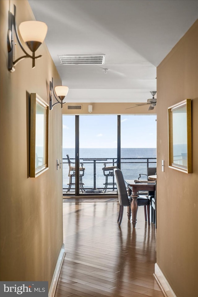 interior space featuring a water view and wood-type flooring