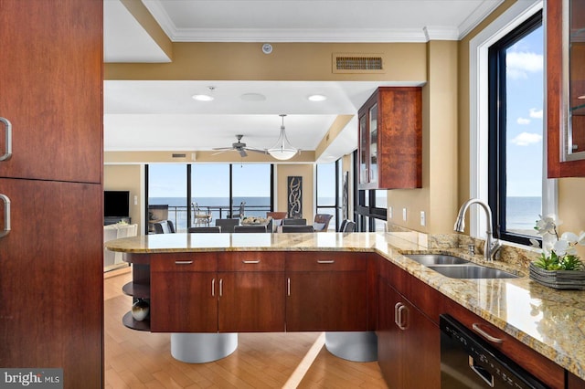 kitchen featuring sink, a wealth of natural light, kitchen peninsula, and a water view