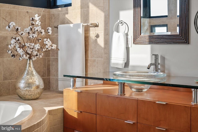 bathroom with vanity and a bath