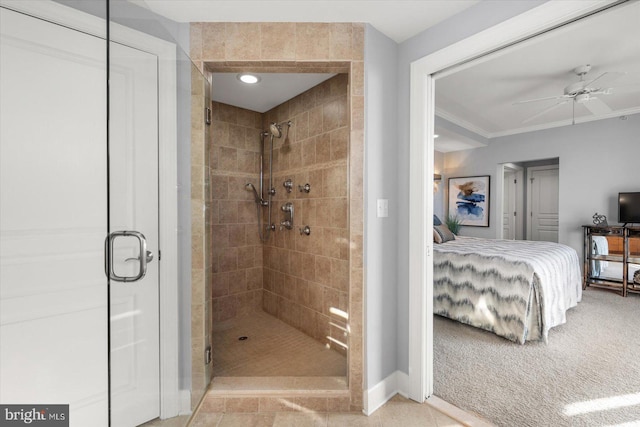 bathroom featuring crown molding, ceiling fan, and an enclosed shower