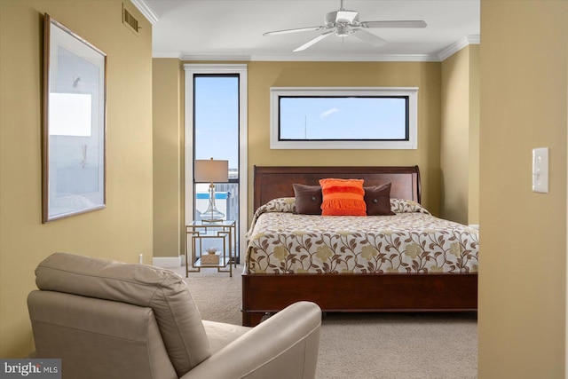 carpeted bedroom with crown molding and ceiling fan