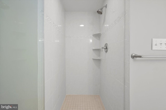 bathroom with a tile shower