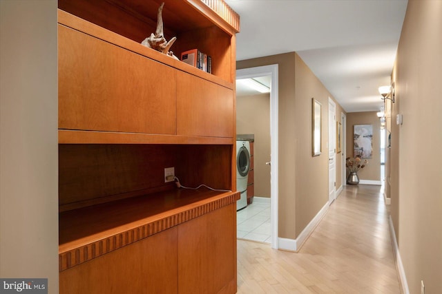 hall featuring washer / dryer and light hardwood / wood-style floors