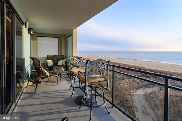 balcony with a water view and a beach view