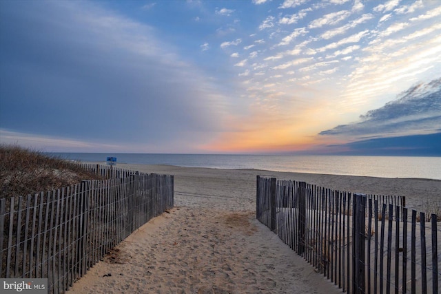 exterior space with a water view and a view of the beach