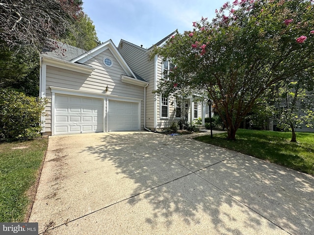 view of front of home with a garage and a front lawn