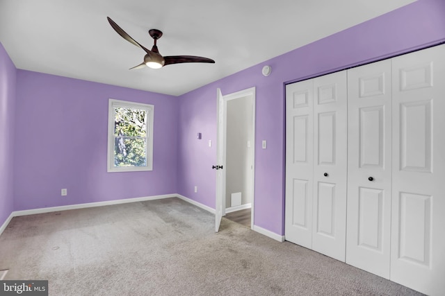 unfurnished bedroom featuring ceiling fan, light carpet, and a closet