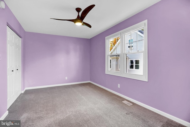 unfurnished room with carpet flooring and ceiling fan