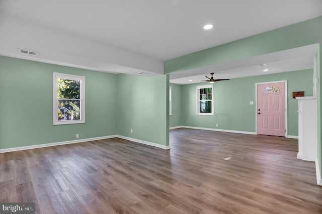 unfurnished living room featuring wood-type flooring and ceiling fan